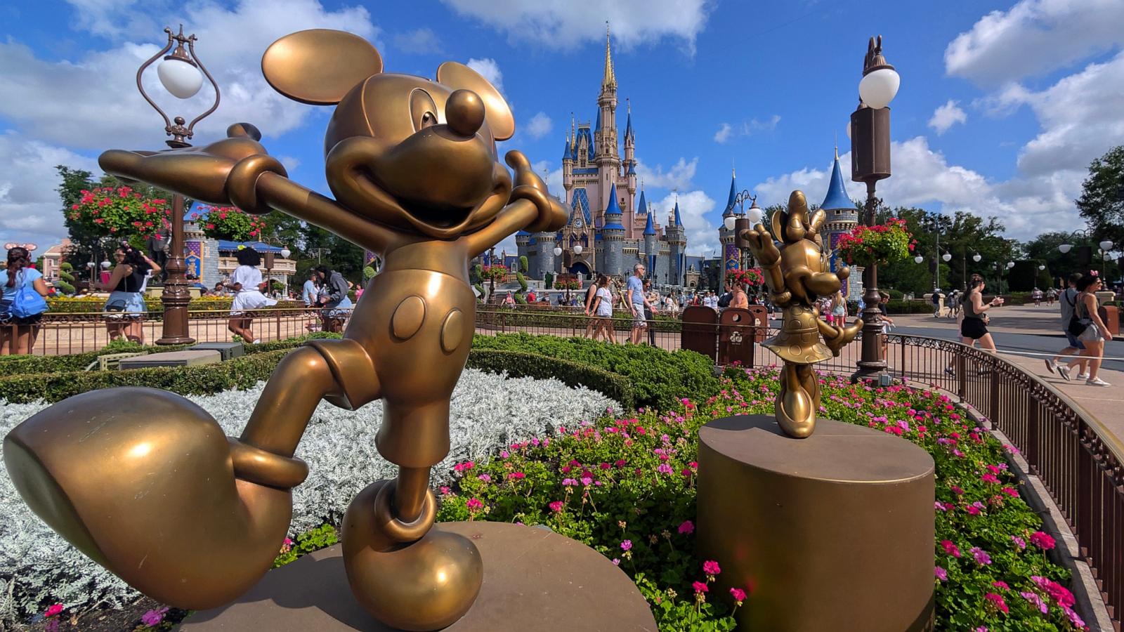 PHOTO: Statues of Mickey Mouse and Minnie Mouse stand in a garden in front of Cinderella's Castle at the Magic Kingdom Park at Walt Disney World on April 3, 2025, in Orlando, Florida.