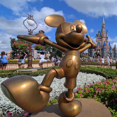 PHOTO: Statues of Mickey Mouse and Minnie Mouse stand in a garden in front of Cinderella's Castle at the Magic Kingdom Park at Walt Disney World on April 3, 2025, in Orlando, Florida.