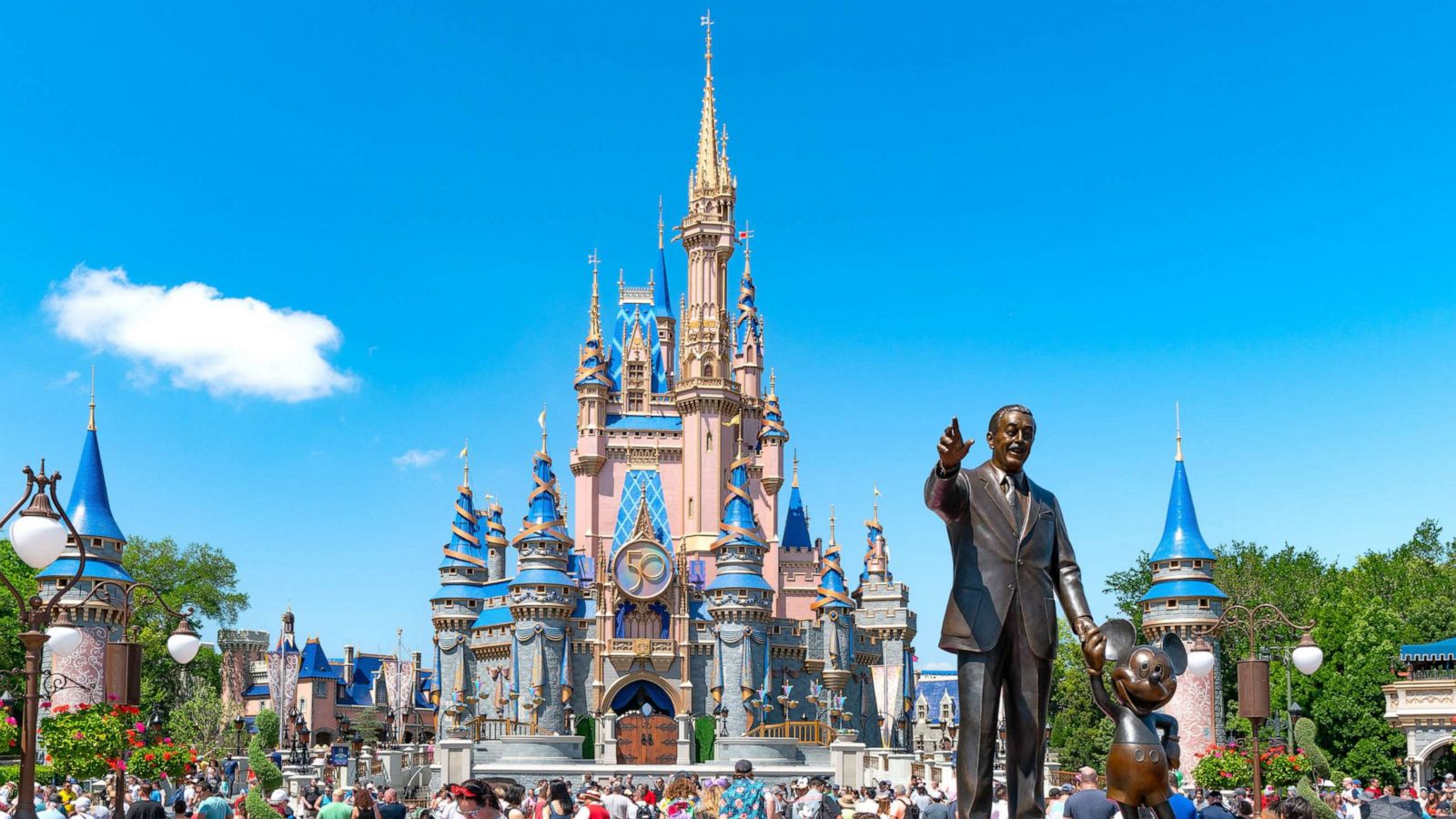 PHOTO: Visitors walk near the Walt Disney "Partners" statue at Magic Kingdom, on April 3, 2022 in Orlando.