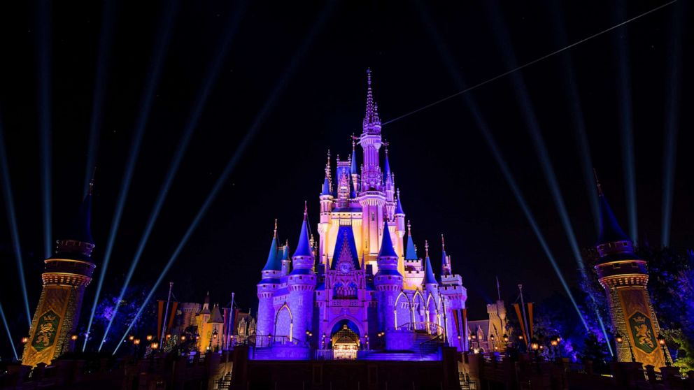 PHOTO: Cinderella Castle inside the Magic Kingdom Park is lit purple and gold, Oct. 11, 2020, at Walt Disney World in Orlando, Fla.