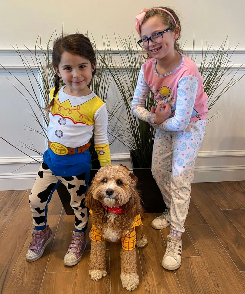 PHOTO: Summer and Sadie Gubenko from Long Island, N.Y., dress up at home with the family dog after their Disney World vacation was canceled due to coronavirus.