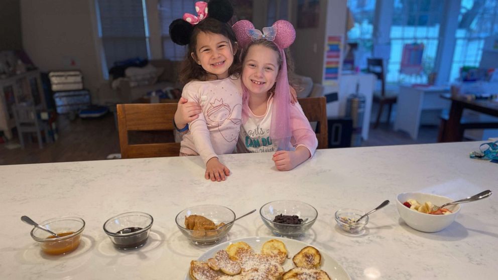 PHOTO: Summer Gubenko, 4, and her sister Sadie, 8, from Long Island, N.Y., pose for a photo in mouse ears at home after their Disney World vacation was canceled due to coronavirus.