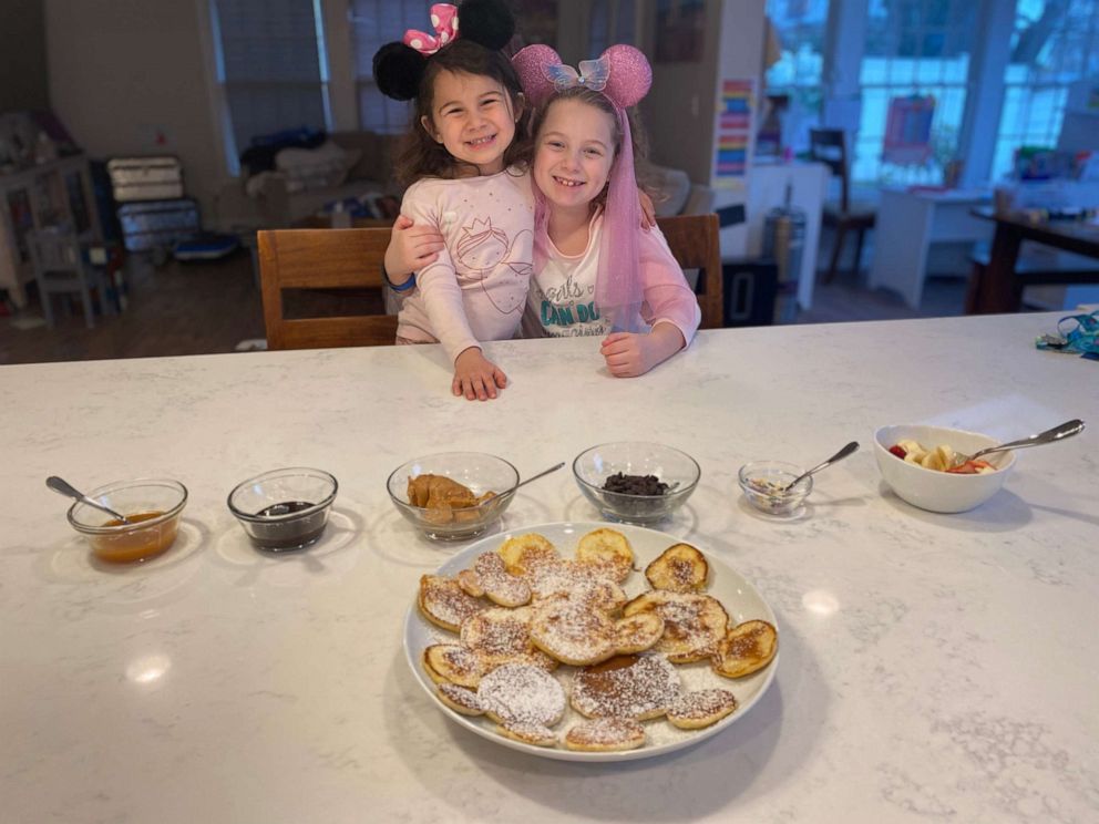 PHOTO: Summer Gubenko, 4, and her sister Sadie, 8, from Long Island, N.Y., pose for a photo in mouse ears at home after their Disney World vacation was canceled due to coronavirus.