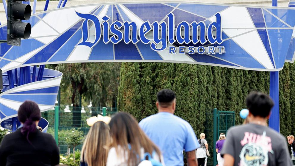 PHOTO: People walk toward an entrance to Disneyland, April 24, 2023, in Anaheim, Calif.