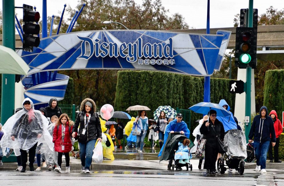 PHOTO: Visitors cross Harbor Blvd. as they leave Disneyland in Anaheim, Calif., March 12, 2020.