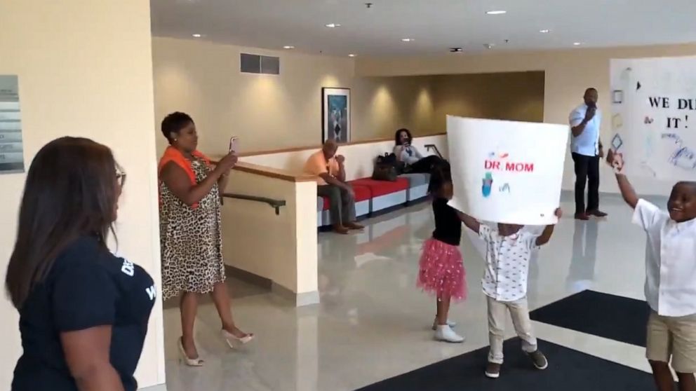 PHOTO: Candace Hall was surprised by her three children after defending her dissertation thesis for a doctorate in education.