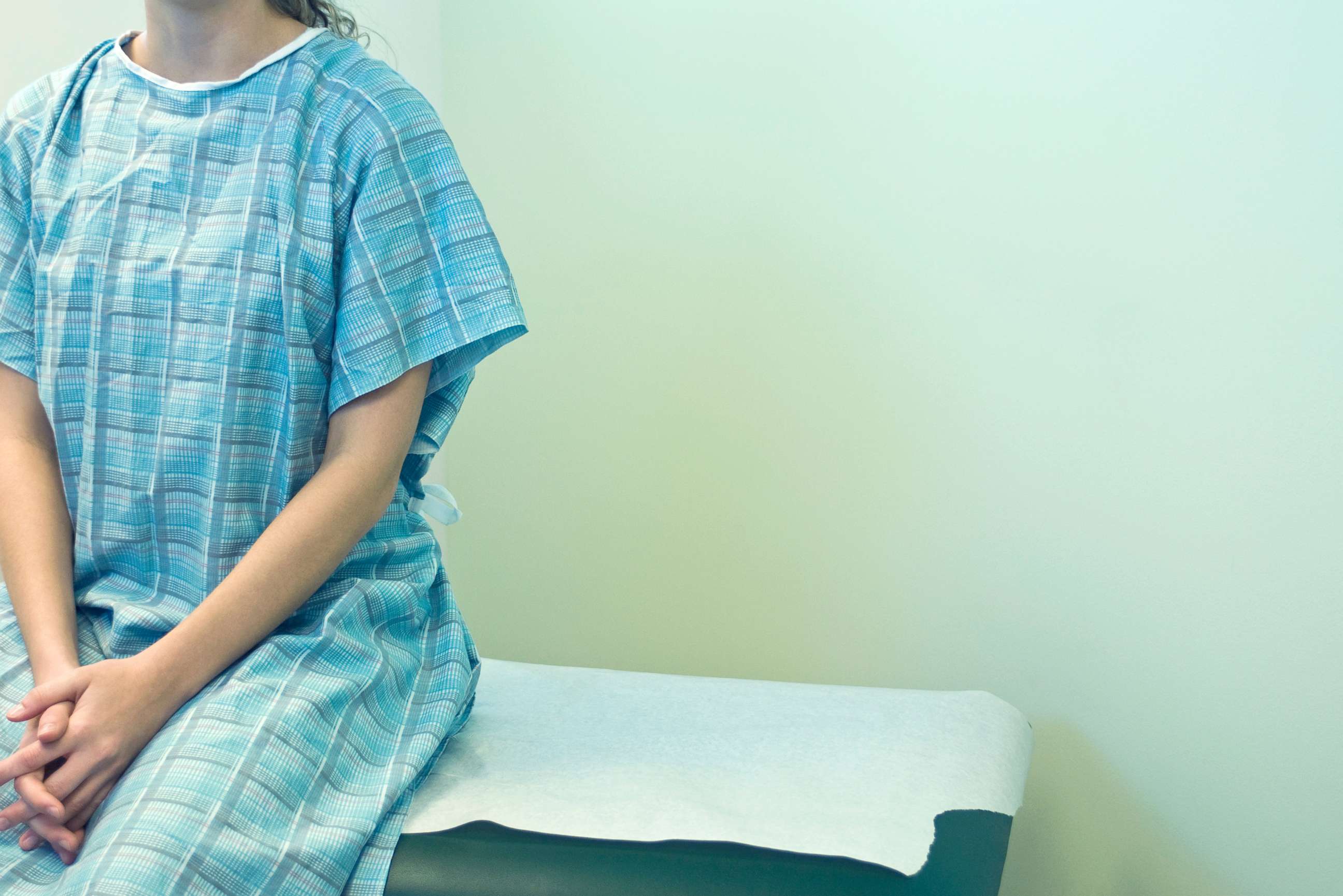 PHOTO: A woman sits in a doctor's office in a stock photo. 