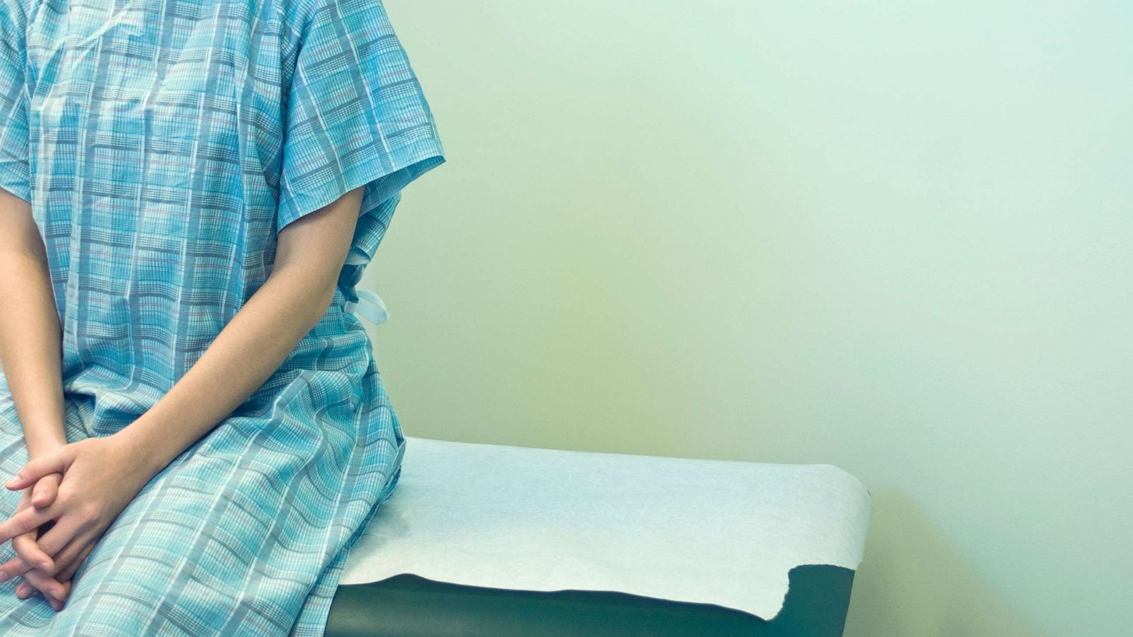 PHOTO: A woman sits in a doctor's office in a stock photo.