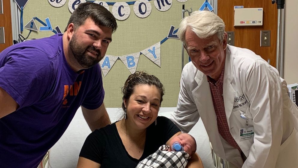 PHOTO: Max and Jenna Hazen pose with Dr. James Stands, of Lexington Medical Center in South Carolina. Stands delivered Jenna Hazen on Jan. 14, 1991, then Max Hazen on Aug. 9 that same year. On Sept. 2, 2020 Stands delivered he couple's newborn son.