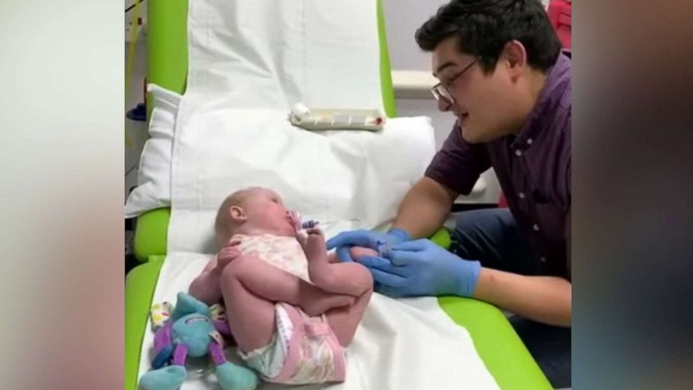 PHOTO: An image made from video shows Dr. Ryan Coetzee sanging Nat King Cole's "Unforgettable" to soothe a 10-month-old baby, Gracey, during blood tests at Raigmore Hospital in Scotland.