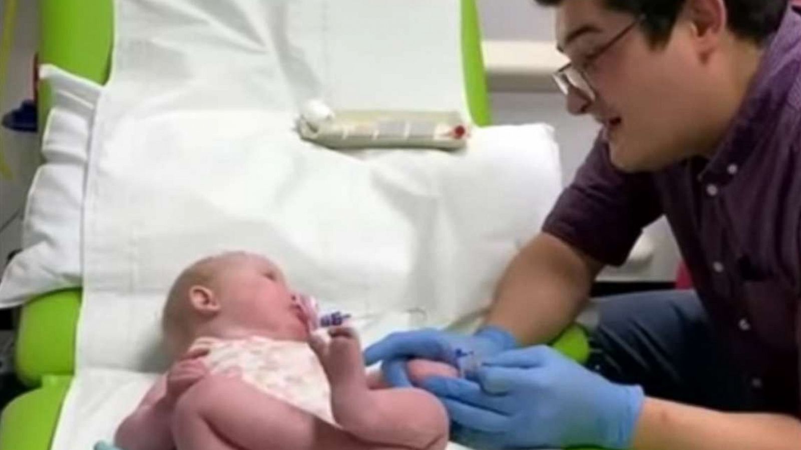 PHOTO: An image made from video shows Dr. Ryan Coetzee sanging Nat King Cole's "Unforgettable" to soothe a 10-month-old baby, Gracey, during blood tests at Raigmore Hospital in Scotland.