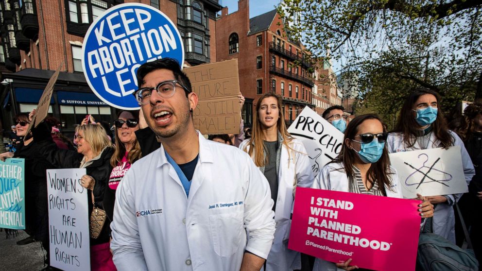 PHOTO: In this May 3, 2022, file photo, a group of doctors and medical workers join protesters gathering in front of the State House to show support and rally for abortion rights in Boston.