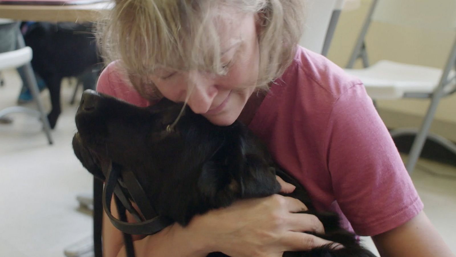 PHOTO: Jeanne Meyer hugs her new dog Angel during a Puppies Behind Bars training session.