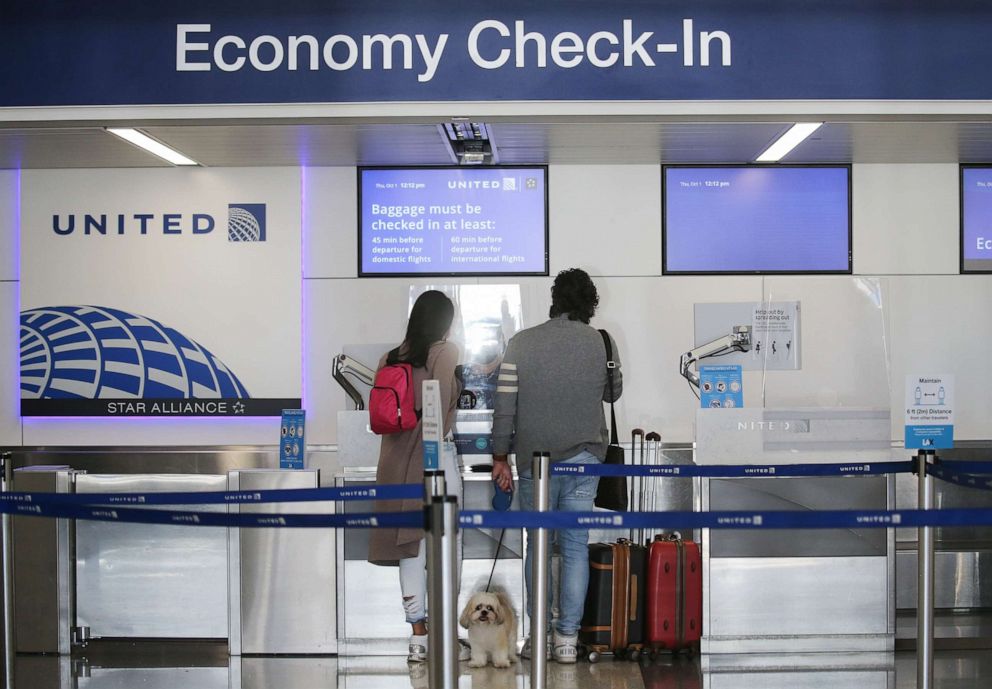 PHOTO: Departing passengers with a dog check in for a United Airlines flight at Los Angeles International Airport on Oct. 1, 2020, in Los Angeles.