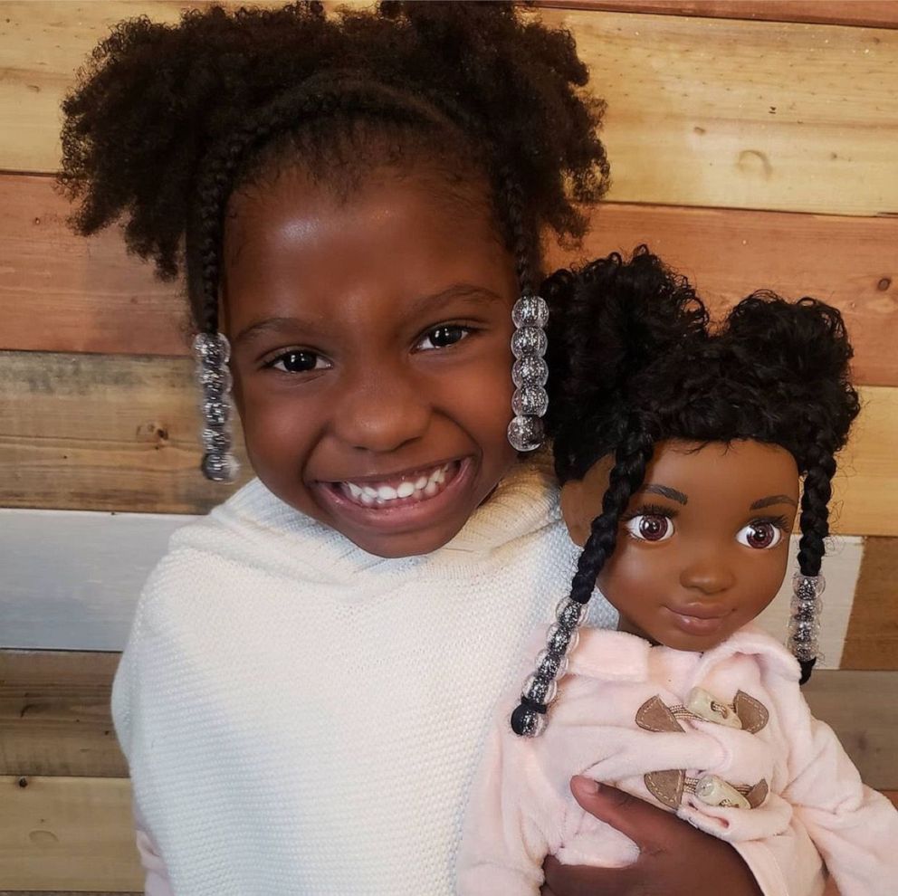 PHOTO: Zoey Jaynia, 4, of Indianapolis, Indiana, smiles alongside her curlfriend, Zoe, from the Healthy Roots Dolls company.