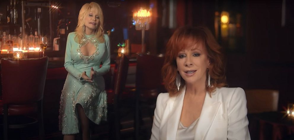 PHOTO: Dolly Parton and Reba McEntire sing in an image taken from the official music video of their new song "Does He Love You," released via YouTube.