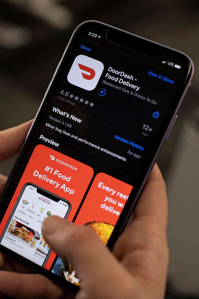 PHOTO: A woman checks the DoorDash food delivery application on her smartphone. 