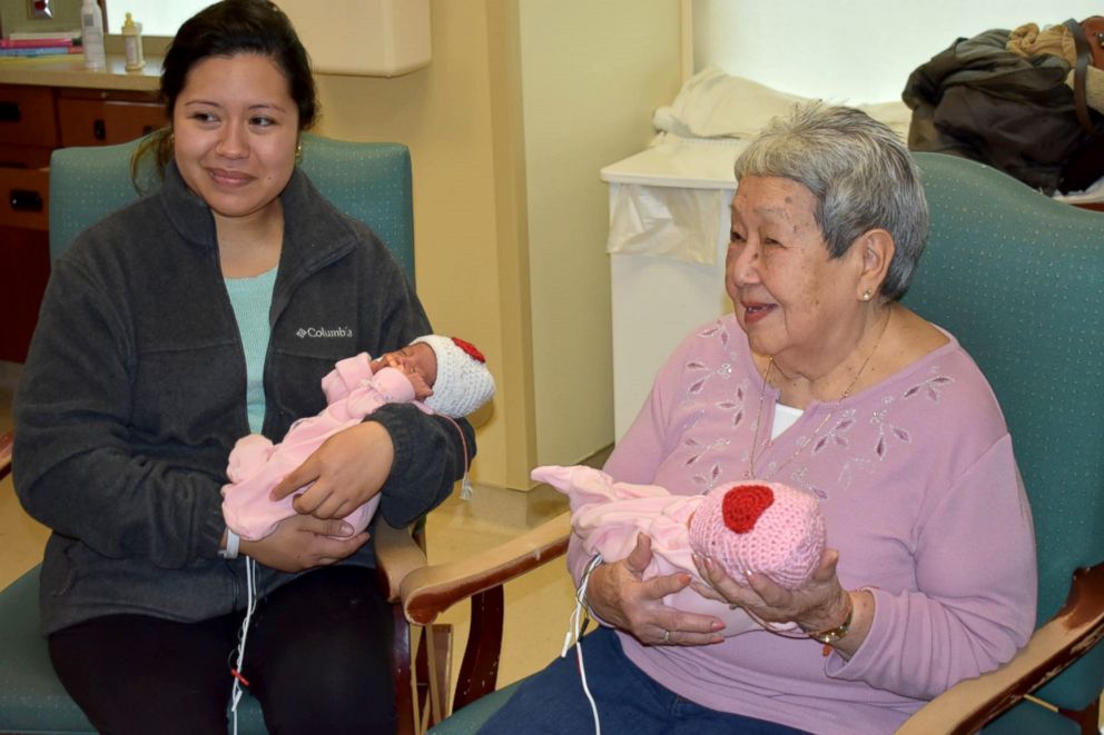 PHOTO: Doris Bender, right, poses with a mom and her newborn twins in Bender's hats at Meritus Medical Center.