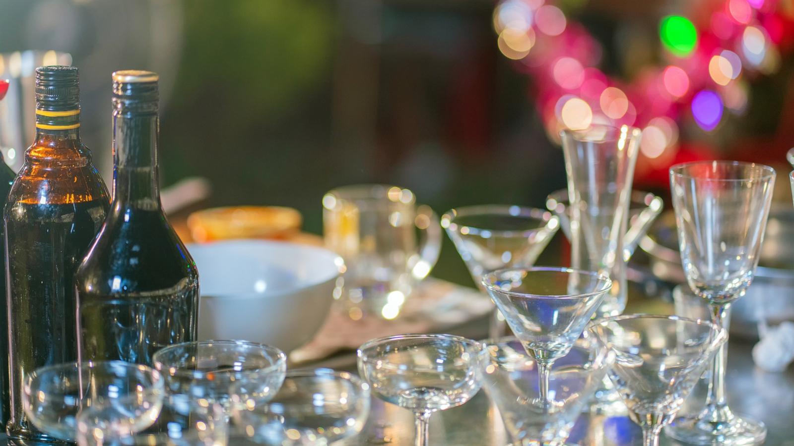 PHOTO: Set of bar accessories for making cocktails with several glasses and bottles of alcohol