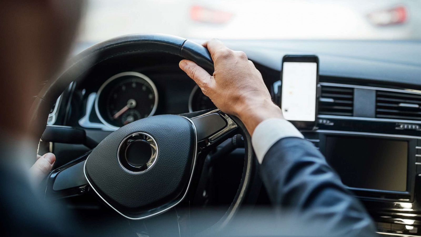 PHOTO: A man dressed in a business suit drives a car in an undated stock photo.