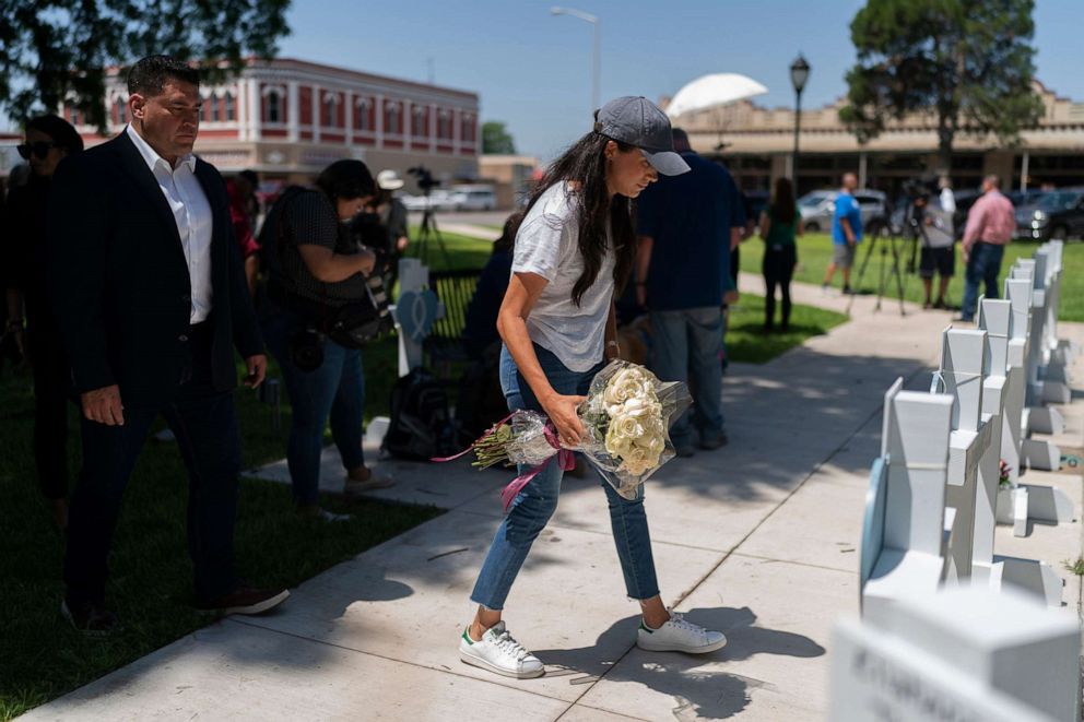 PHOTO: Meghan Markle, Duchess of Sussex, visits a memorial site with flowers, May 26, 2022, to honor the victims killed in this week's elementary school shooting in Uvalde, Texas.