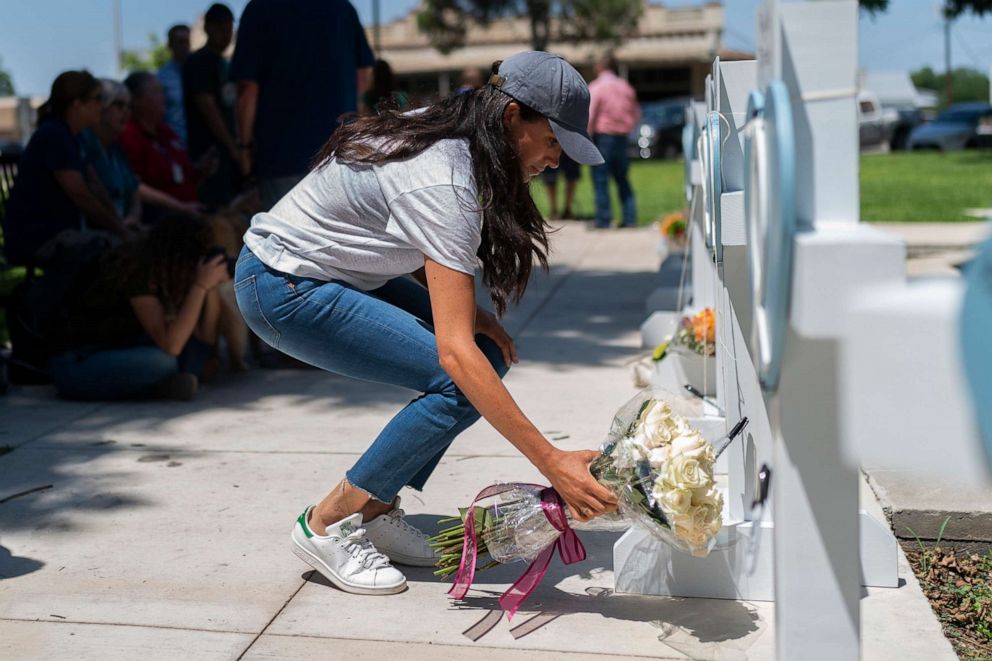 PHOTO: Meghan Markle, Duchess of Sussex, leaves flowers at a memorial site, May 26, 2022, for the victims killed in this week's elementary school shooting in Uvalde, Texas.