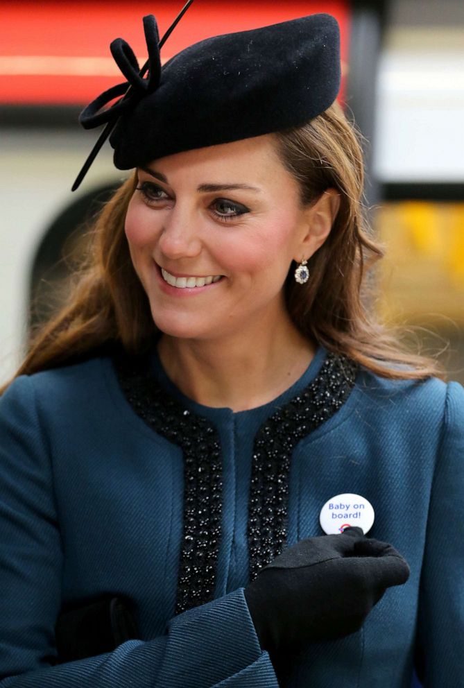 PHOTO: Catherine, Duchess of Cambridge, wears a Transport For London (TFL) badge that reads "baby on board," given to her during a visit to Baker Street tube station with Queen Elizabeth II and Prince Philip, Duke of Edinburgh, in London, March 20, 2013.