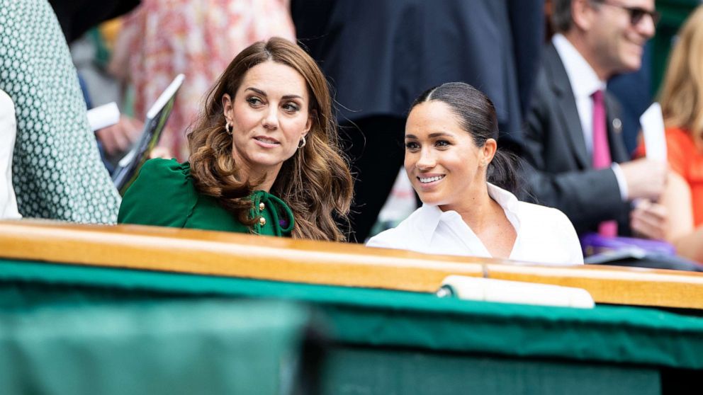 PHOTO: Catherine, Duchess of Cambridge talks with Meghan, Duchess of Sussex in the royal box before the start of the Women's Singles Final between Simona Halep and Serena Williams at The Wimbledon Lawn Tennis Championship, July 13, 2019, in London.