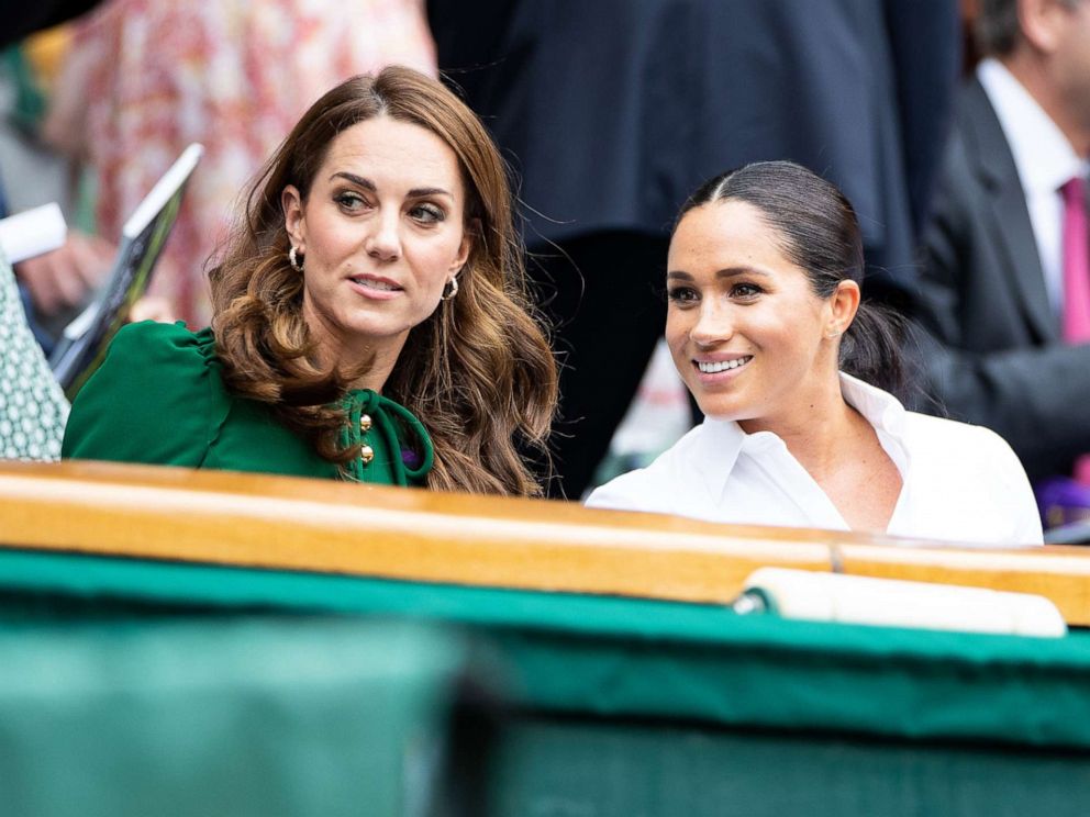 PHOTO: Catherine, Duchess of Cambridge talks with Meghan, Duchess of Sussex in the royal box before the start of the Women's Singles Final between Simona Halep and Serena Williams at The Wimbledon Lawn Tennis Championship, July 13, 2019, in London.
