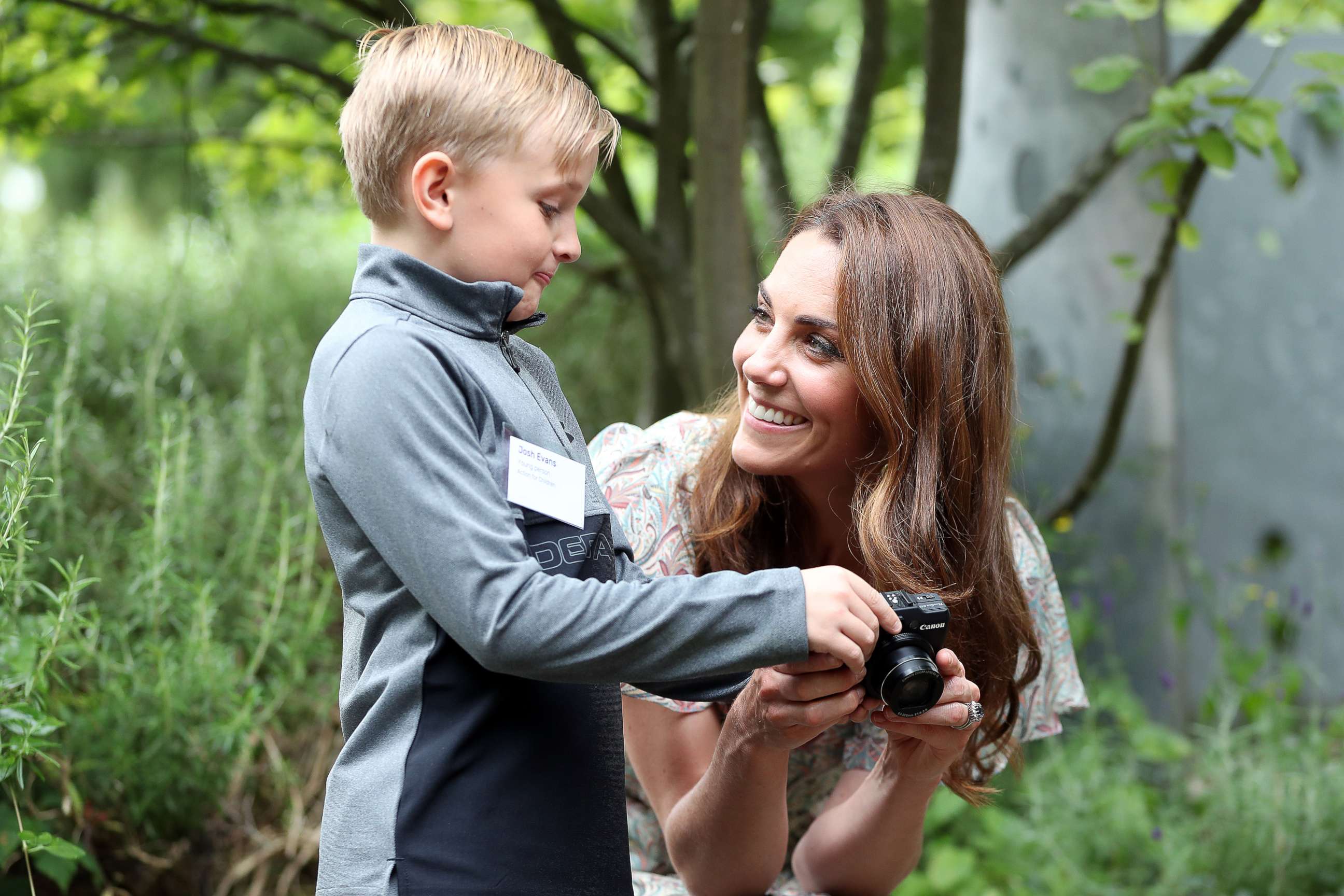 PHOTO: Catherine, Duchess of Cambridge speaks with Josh Evans at photography workshop for Action for Children, run by the Royal Photographic Society at Warren Park on June 25, 2019, in Kingston, England.
