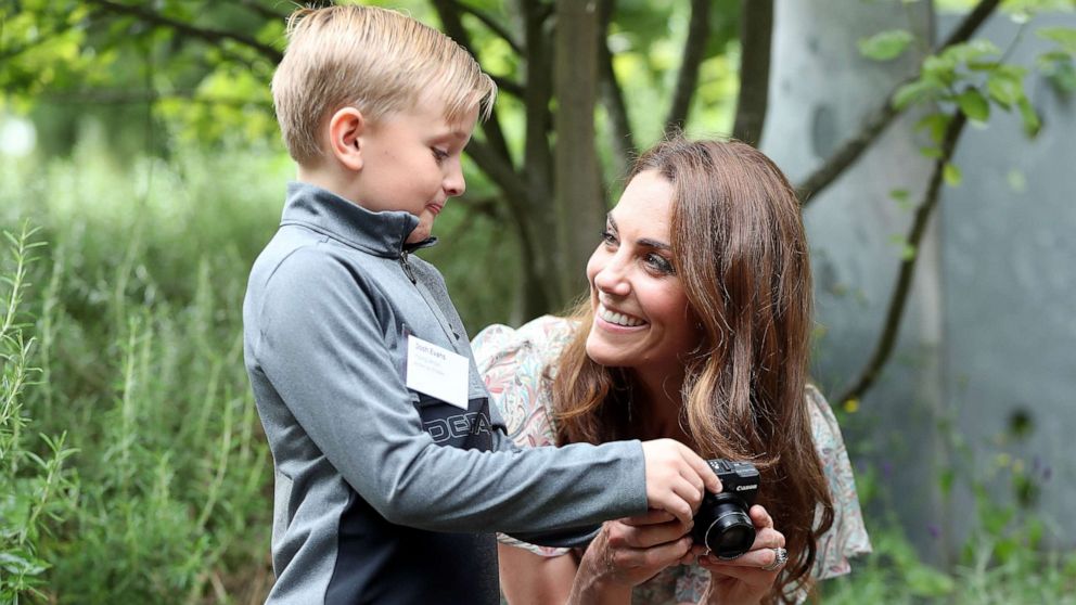 PHOTO: Catherine, Duchess of Cambridge speaks with Josh Evans at photography workshop for Action for Children, run by the Royal Photographic Society at Warren Park on June 25, 2019, in Kingston, England.