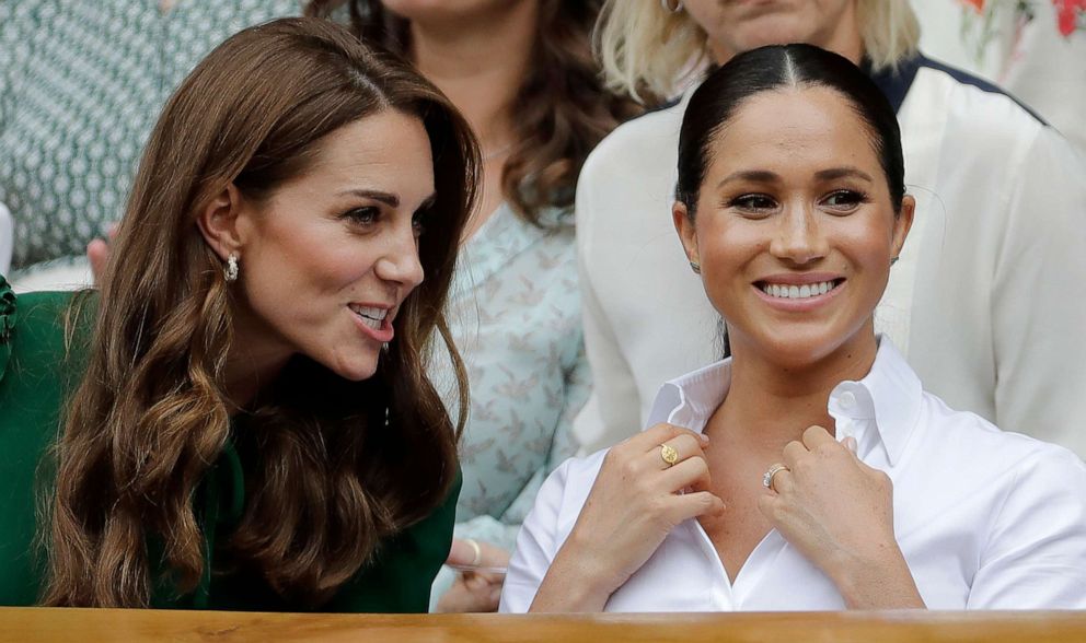 PHOTO: Kate, Duchess of Cambridge, left, and Meghan, Duchess of Sussex chat as they sit in the Royal Box on Centre Court to watch the women's singles final match between Serena Williams of the U.S. and Romania's Simona Halep  in London, July 13, 2019. 