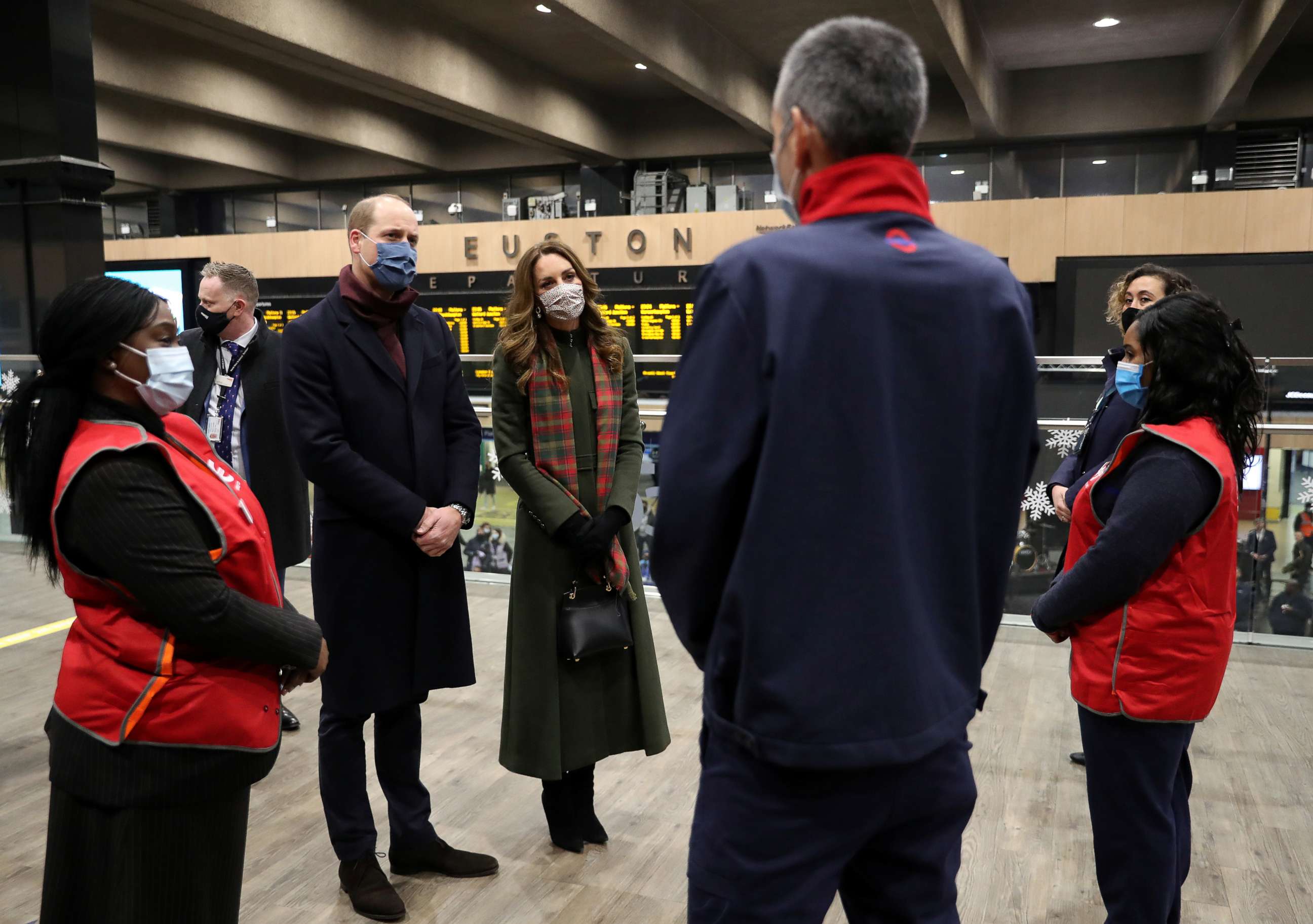 PHOTO: Britain's Prince William and Catherine, Duchess of Cambridge, speak to transport workers at London Euston Station