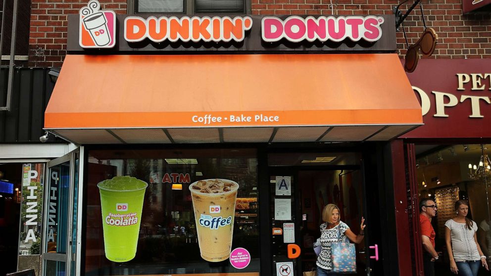 PHOTO: A woman walks out of a Dunkin' Donuts in New York City.