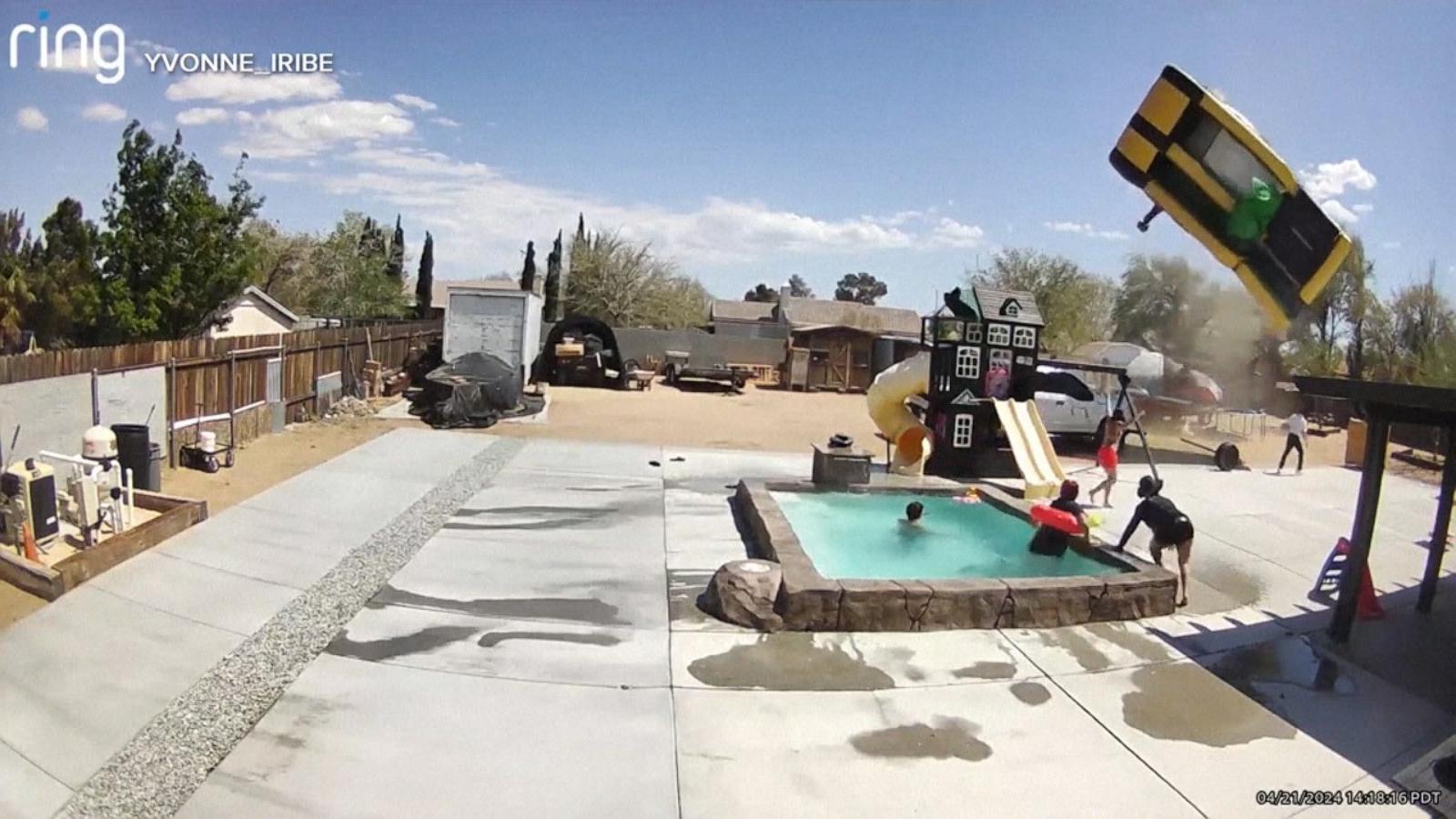 PHOTO: Security camera footage shows a dust devil lifting away an inflatable bounce jumper at a California home.