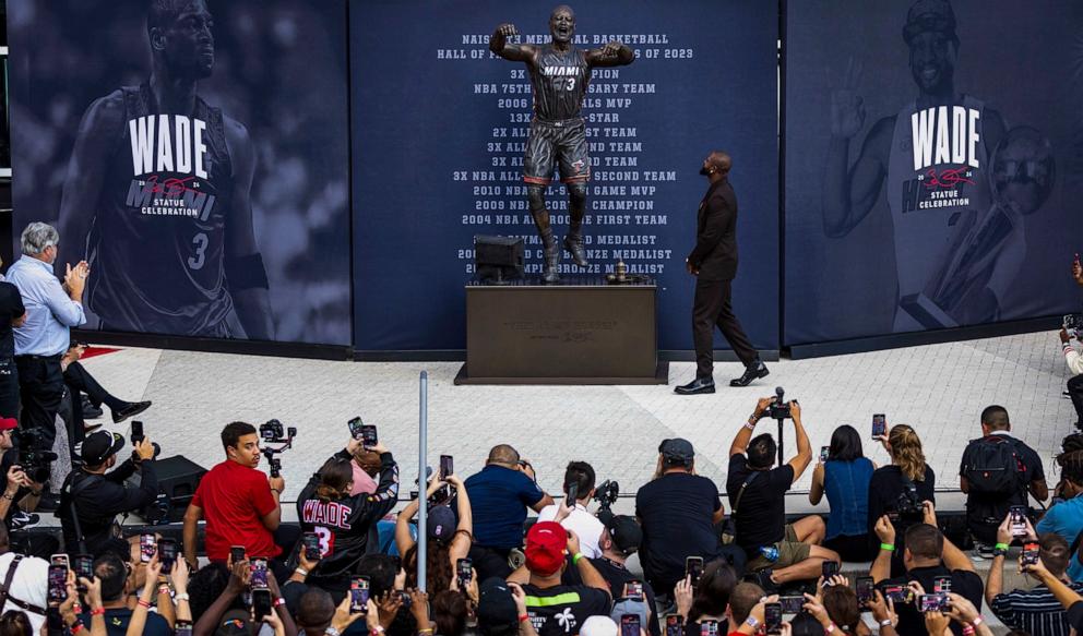 PHOTO: Dwyane Wade checks out his statue after it was unveiled during an unveiling ceremony in front of Kaseya Center, Oct. 27, 2024, in Miami. 