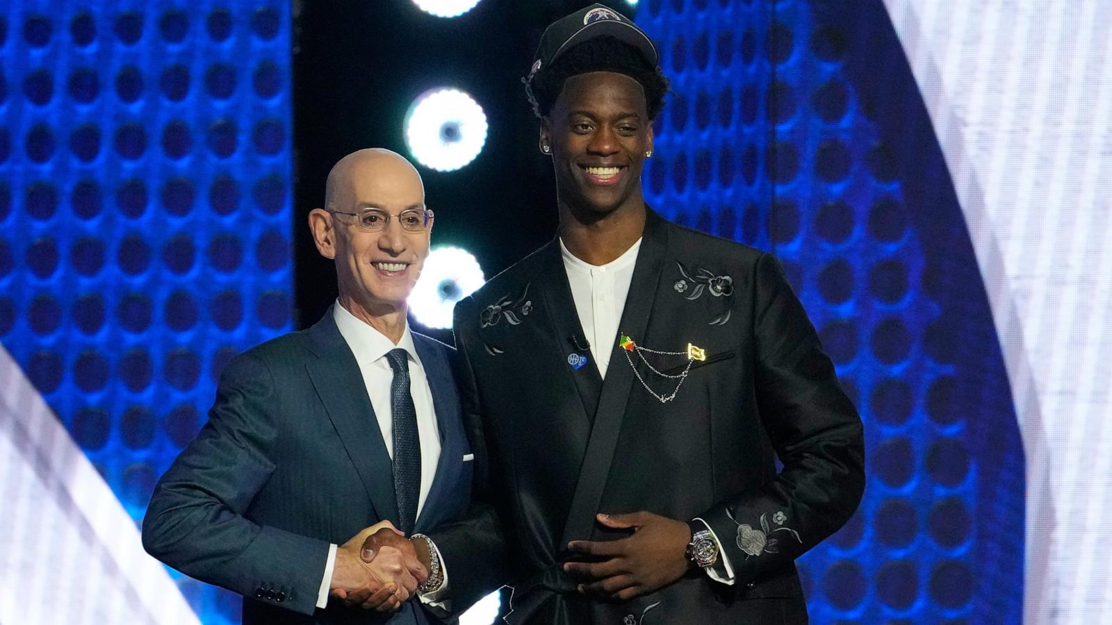 PHOTO: AJ Dybantsa, right, poses for a photo with NBA commissioner Adam Silver, left, after being selected by the Washington Wizards as the first pick in the first round of the NBA basketball draft, June 23, 2026, in New York.