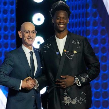 PHOTO: AJ Dybantsa, right, poses for a photo with NBA commissioner Adam Silver, left, after being selected by the Washington Wizards as the first pick in the first round of the NBA basketball draft, June 23, 2026, in New York.