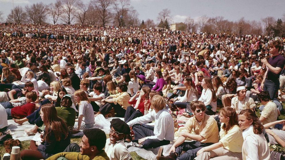 PHOTO: Crowds of young men and women sit in a park during celebrations for Earth Day, circa 1970.