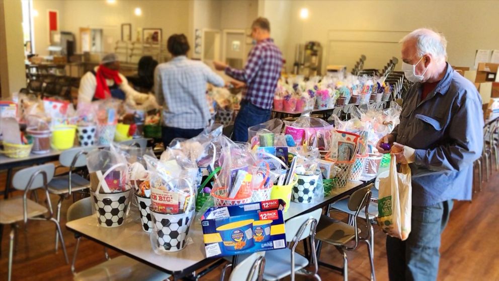 PHOTO: Community volunteers kept their social distance while helping to organize the 300 donated Easter baskets in Charlotte, N.C.