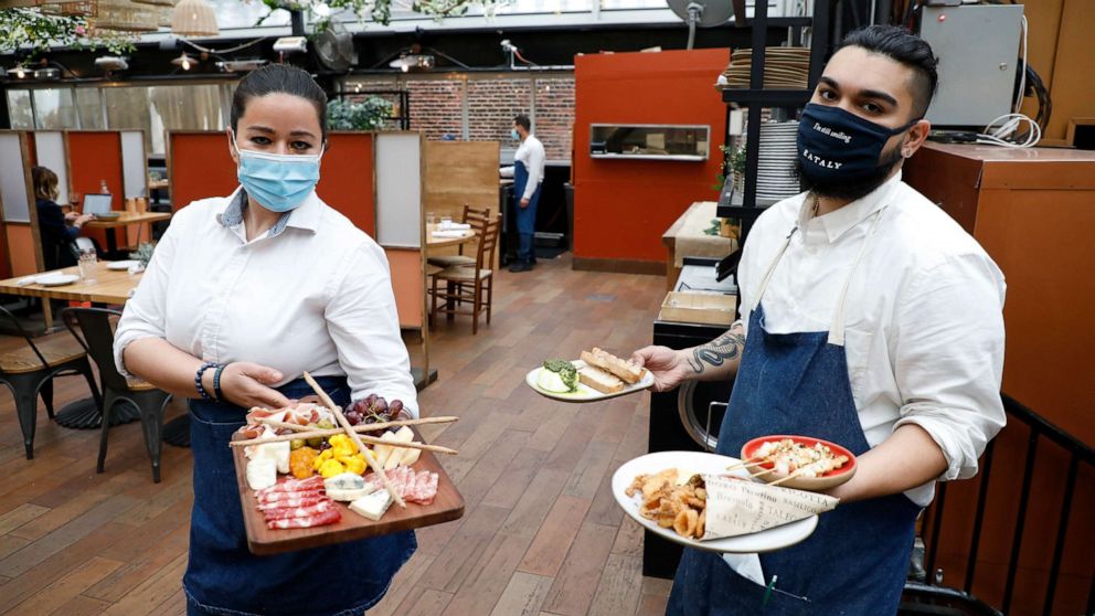 PHOTO: Staffers work the opening of a restaurant on the Eataly Flatiron Rooftop on April 15, 2021, in New York.