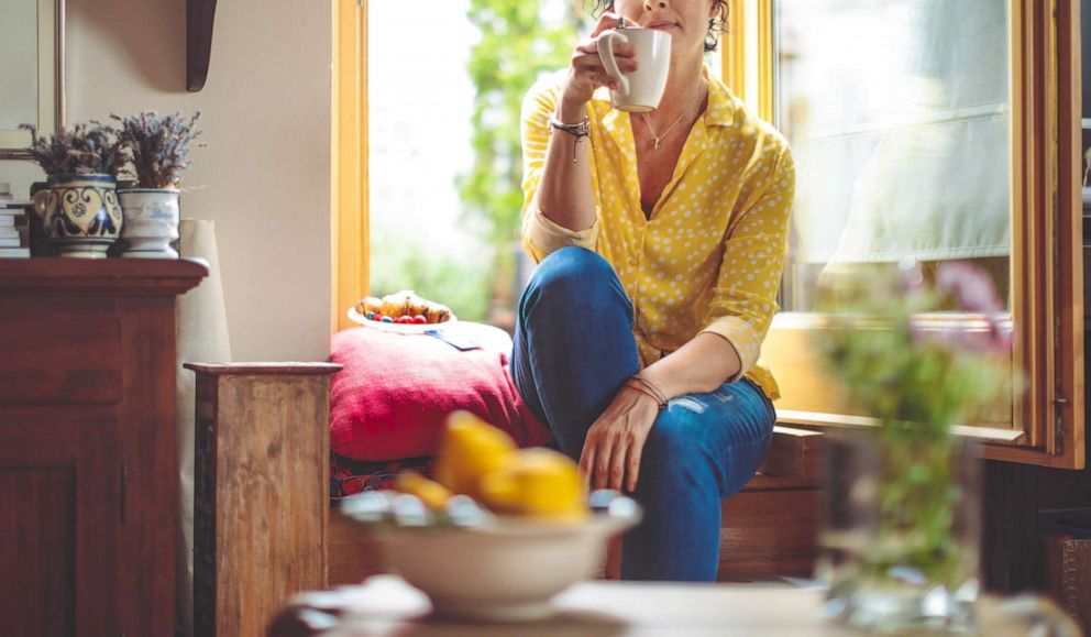 PHOTO: A woman is pictured having coffee at home.