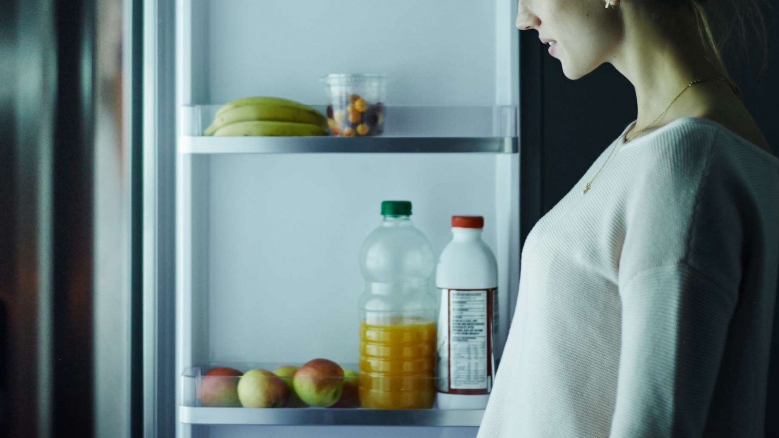 PHOTO: A young woman opens a refrigerator in this undated stock image.