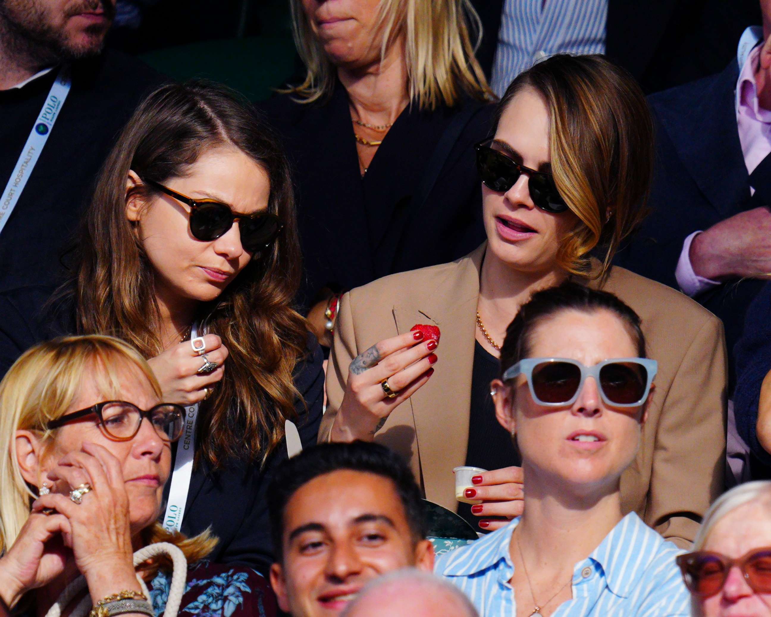 PHOTO: Cara Delevingne and girlfriend Minke eat strawberries and cream in the stands at the Wimbledon Tennis Championships, July 10, 2023, in London.