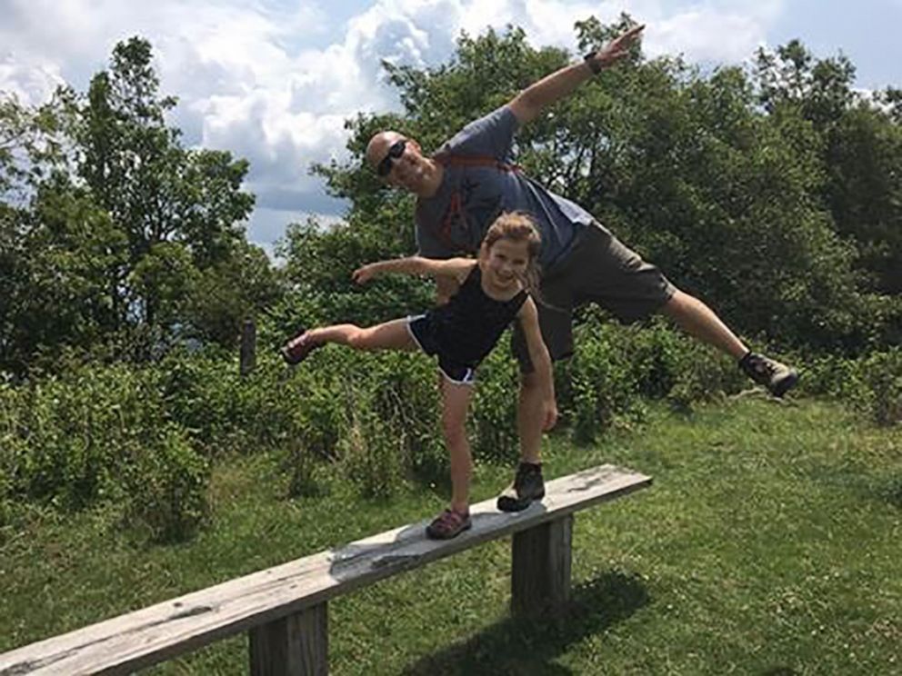 PHOTO: Brad Marshall and his daughter Eden practice balancing on a wooden beam.