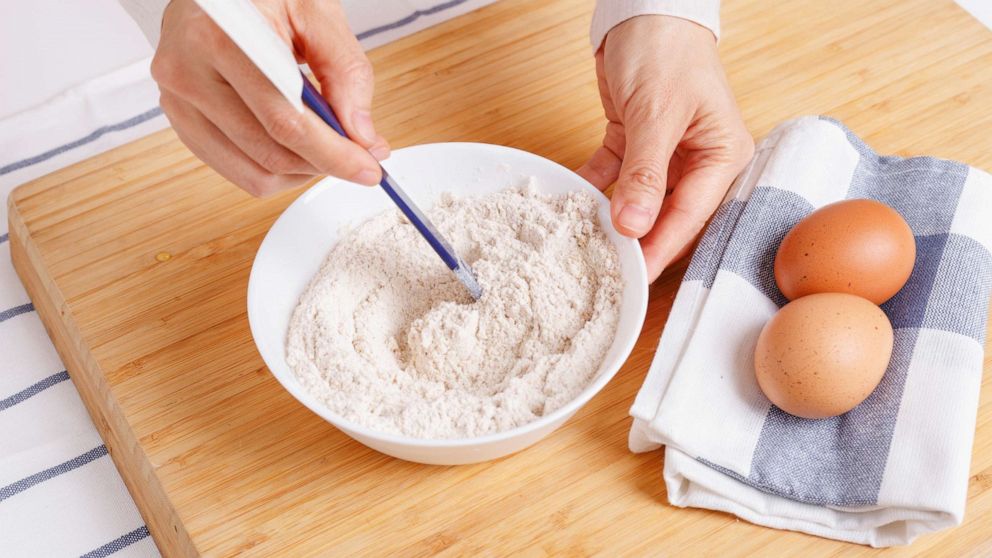 PHOTO: Stock photo of woman mixing ground flaxseed and flour.