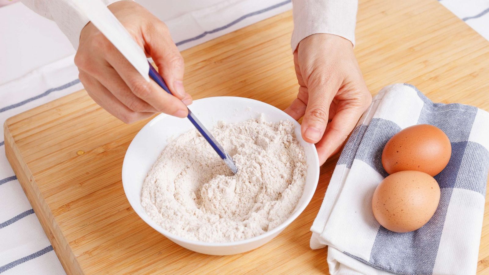 PHOTO: Stock photo of woman mixing ground flaxseed and flour.