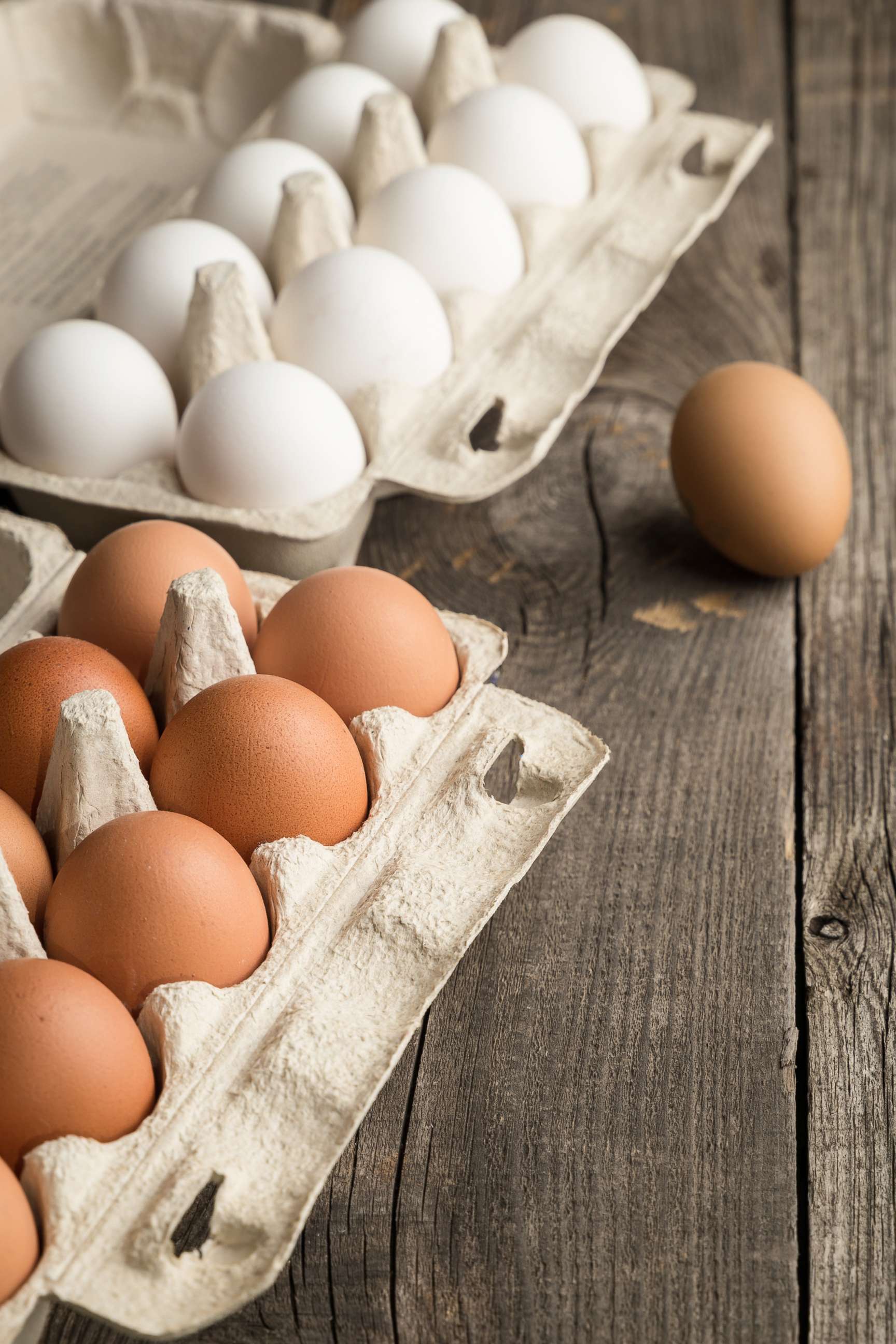 PHOTO: Eggs are seen in box container on a wooden table in this stock photo.