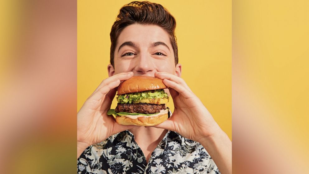 Eitan Bernath eats a Guac Burger. 