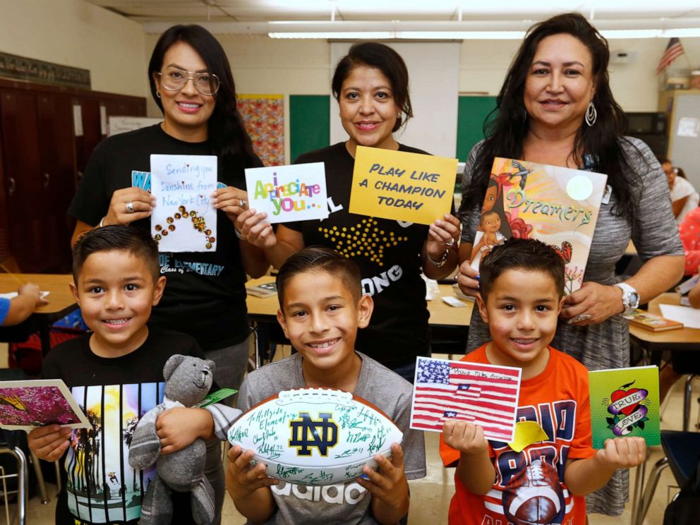PHOTO: Elvira Flores, standing center, poses with students and colleagues at Hillside Elementary.